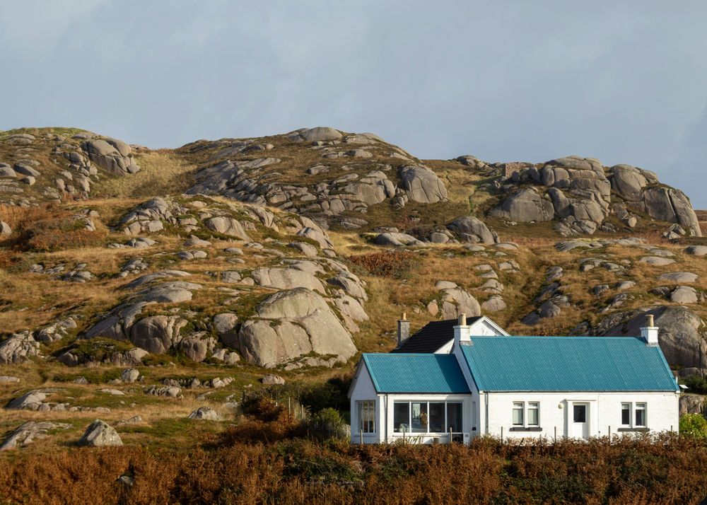 White Rural Cottage set against rocky backdrop Isle of Mull