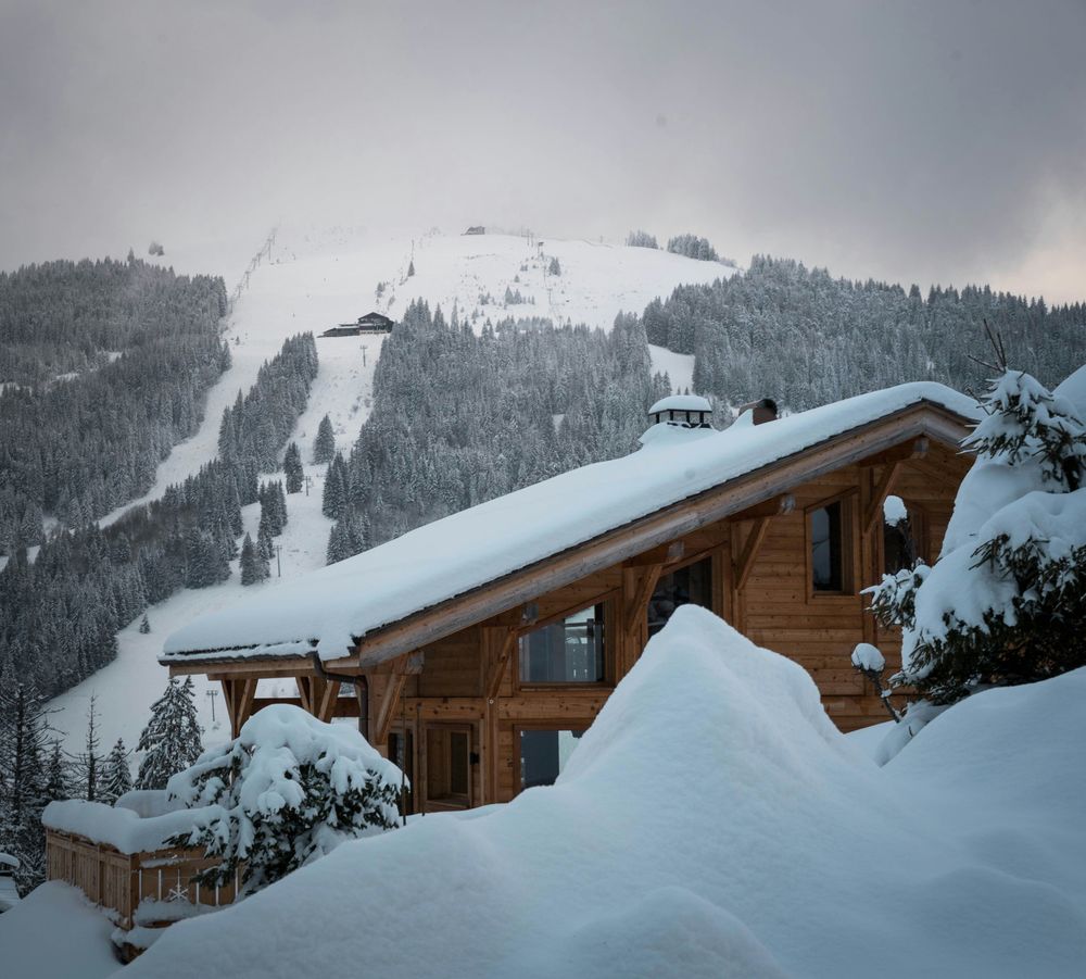 Luxury ski chalet in Les Gets with snow foreground.